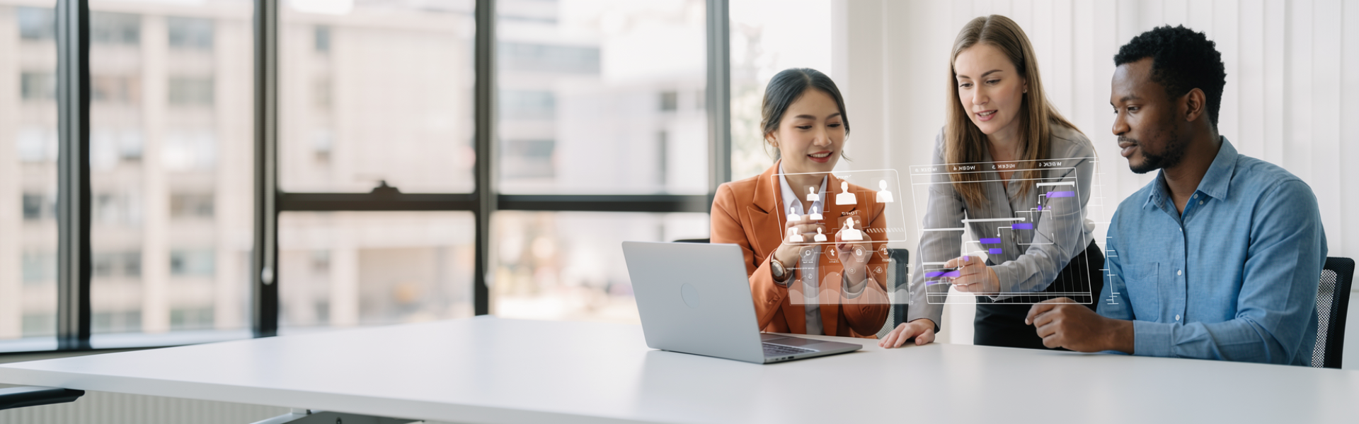 three people reviewing tech on laptop with graphic overlay